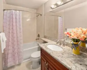 Full Bath presents single vanity, quarts countertop, Kohler sink/tub/toilet, and ceramic floor/wall tile.