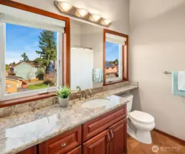 ADU Full Bath features double vanity, quarts countertop, Kohler sink/toilet, ceramic floor tile, and Milgard casement windows.