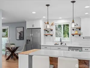 Convenient breakfast bar allows you to visit with guests while preparing a meal
