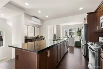 Warm engineered hardwoods flow throughout.