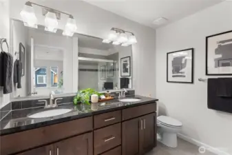 Full en-suite primary bath with dual sinks.