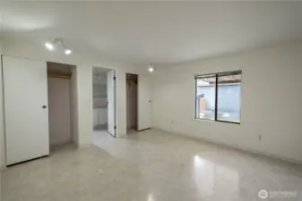 The large primary bedroom is connected to an ensuite bathroom with tub.