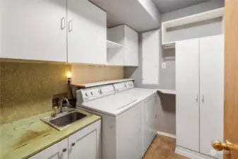 Step in from the garage into the spacious laundry room with sink and extra storage.