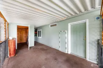 Private covered side porch, side door and access to insulated shed