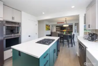 Amazing kitchen has island with storage on both sides and beverage fridge, double ovens and pantry.