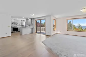 Living room, dining area with a slider to the deck and open kitchen