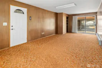 Man door leads to the side yard, sliding door in back leads to the carport.