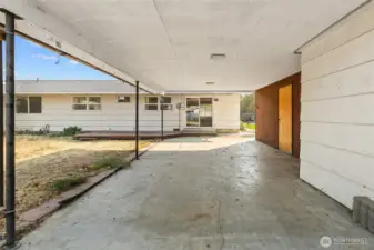 Large detached carport with storage on the right side.