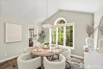 The dining room features a new chandelier, light and bright windows and a dramatic vaulted ceiling.