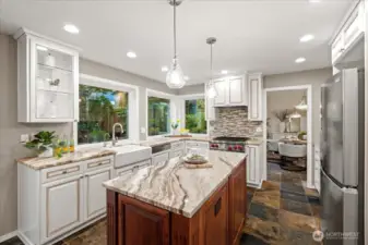 The wall of windows in the kitchen overlook the tranquil backyard and flood the room with natural light.