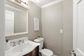 Main floor powder room with new vanity and Calcutta marble counter.