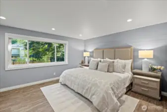 The main bedroom is a luxury retreat after a long day. This space has been upgraded with recessed lighting, custom silhouette Hunter Douglas light enhancing shades and porcelain wood plank tiles with radiant heat.