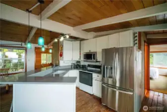 Open concept kitchen with quartz counter tops & wrap around eating bar.