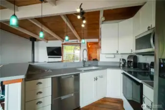 Open concept kitchen with quartz counter tops & wrap around eating bar.