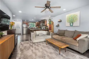 Unit 2 – Living Room: Open-concept design  Wide living room footprint easily fits multiple seating layouts and offers a clear view into the updated kitchen for better connectivity.