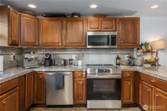 Unit 2 - Cooking & Prep Area Close-up  Close-up view of the stainless steel appliance suite, tile backsplash, and extensive cabinetry — a great setup for meal prep and home-cooked dinners.