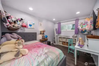 Unit 2 - A comfortable second bedroom with durable vinyl plank flooring and a wide window that brings in natural light. Ideal as a guest room, nursery, or home office — perfect for house-hackers or multi-use living.