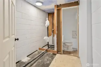 Bathroom with exposed plumbing and Jack-and-Jill access to the third bedroom.