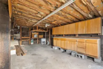 Generous garage with storage cabinets.