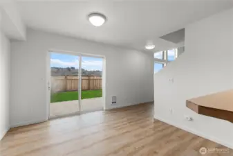 Sliding glass door leads to large yard and patio