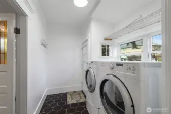Remodeled laundry room and mud room with access to the fully fenced backyard and garage.