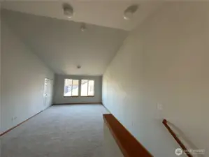 Walk upstairs to large vaulted family/rec room with storage