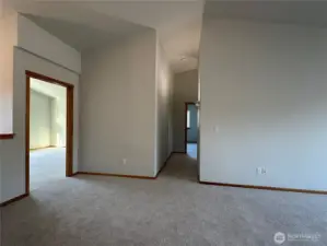 Hallway upstairs heading to third bedroom at the end by the utility room