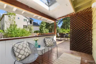 Step outside into the covered portion of the deck featuring a skylight and privacy screen. Could be easily converted to a catio.