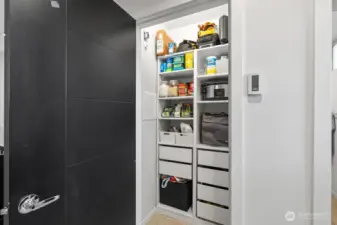 Huge coat/storage closet with custom built-ins.