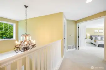 The upper landing. Double doors lead to the primary bedroom.