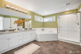 Luxurious 5-piece primary bath with a dual sink vanity, soaking tub, and separate shower.