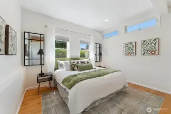 Primary suite with soaring ceiling and flooded with natural light.