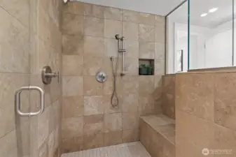 Your dream-come-true shower with built-in seat, shower niche, and double shower heads.
