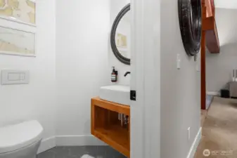 On the main floor, this half bathroom is both beautiful and functional.