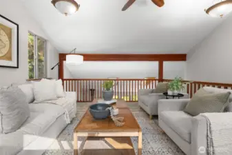 This loft area serves as an excellent secondary living area, open to the downstairs and filled with natural light.