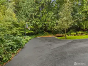 Parking galore, the asphalt driveway is expansive and has room for it all.