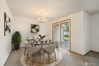 The virtually staged dining area off the living room shows the private patio