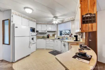 Circular style kitchen has some newer appliances. Plenty of storage space and meal prep areas. Ceiling fan and updated lighting for your convenience. Garden view window lets you look out toi the Gazebo area.