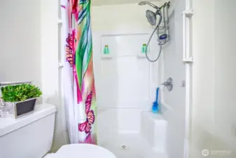 Guest bath has seated, step in shower with rain head and handl held device. Grab bars for your convenience and safety.