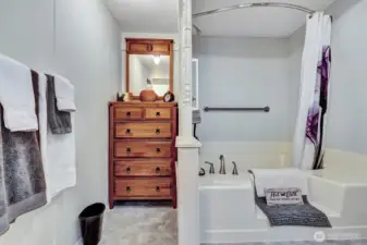 Built in dresser in the primary bath. Great place for all your linens etc. Enjoy a bubble bath in the step in soaking tub. Grab bars for your safety. Shower for your convenience. Escape to this private bath an relax and unwind from the day.
