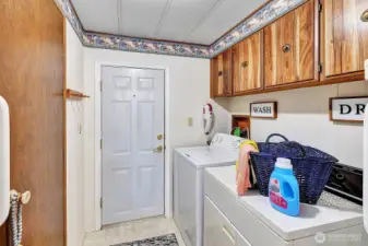 Utility room has access door to guest bath and access door to the carport area. Storage cabinets for all your laundry necessitates. Washer and dryer are included in the sale.