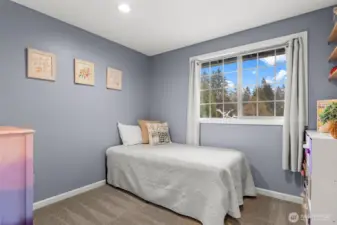 This joyful third bedroom basks in natural lighting and provides a great view of the front yard cherry blossoms!