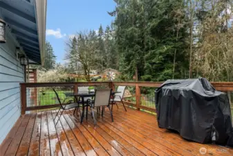 Transition smoothly to the outside deck overlooking the backyard through the sliding glass doors!