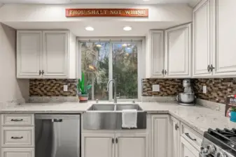 Updated in 2017, this farm style kitchen has updated tiling, can lights, countertops, farm sink, and more!