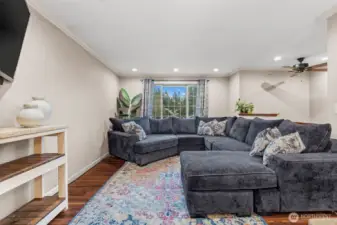 Illuminating this open-concept space, this expansive living room centralizes itself as the heart of the home.