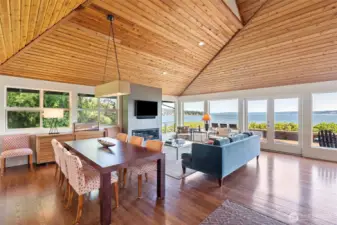Main living space with hardwood floors and vaulted cedar-planked ceiling