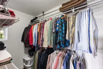 Primary walk-in closet with adjustable shelving
