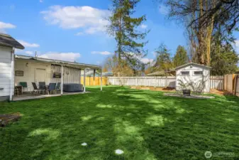 Back yard and covered patio and she shed/man cave. Hot tub and TV stays!