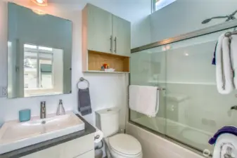 Vaulted windows provide for a bright full bath.
