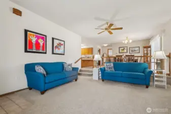 Tall ceilings and a ceiling fan and gas fireplace and great room for a entertainment center